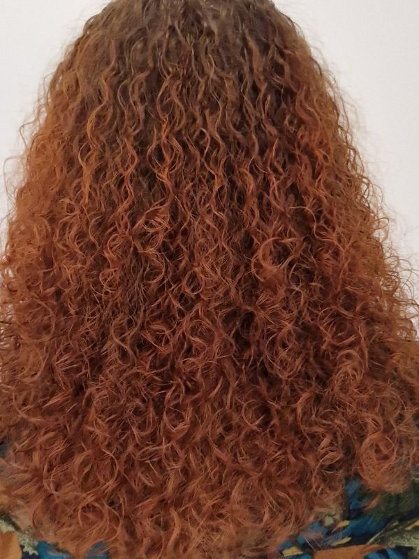 Beautiful perm with colour treatment by Hair Studio Niki Newd® — soft, voluminous curls with radiant, multidimensional tones for a fresh new look.