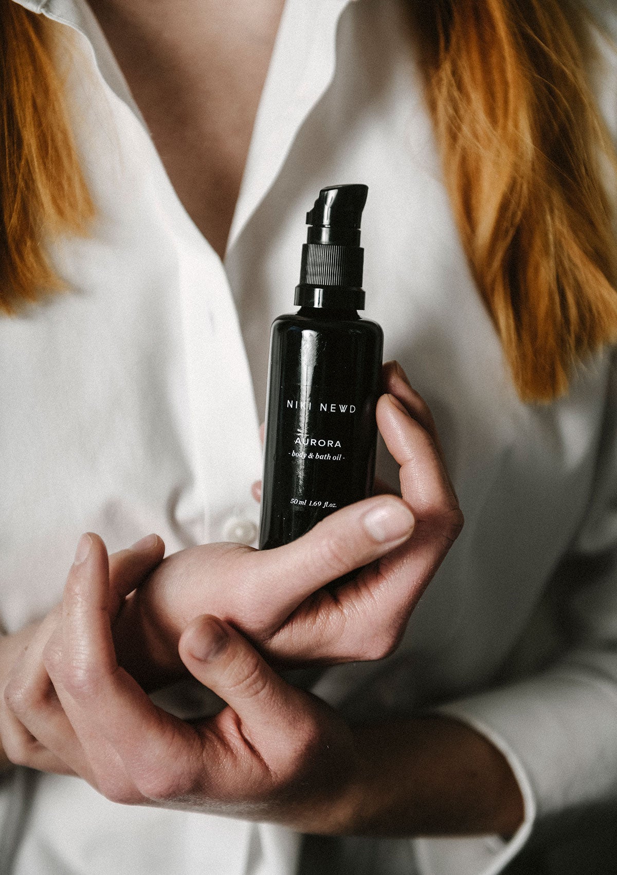 Get glowing skin with Niki Newd® Aurora — luxurious body oil for smooth, radiant skin tone.