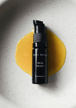 Niki Newd® Skin Velvet serum in a glass pipette – antioxidant oil serum with a rich golden tone that smooths and balances the skin.
