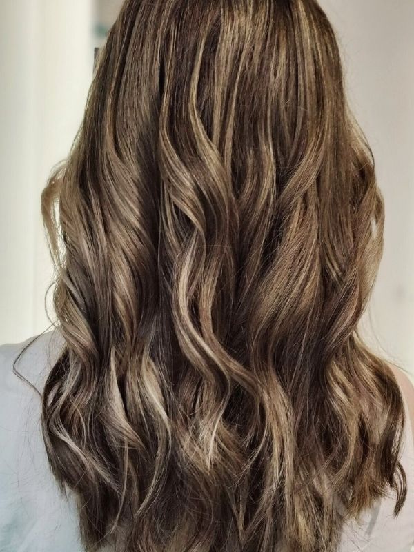 Soft balayage on dark hair created at Niki Newd® Hair Studio – naturally blended caramel and chocolate tones for a radiant, dimensional look.