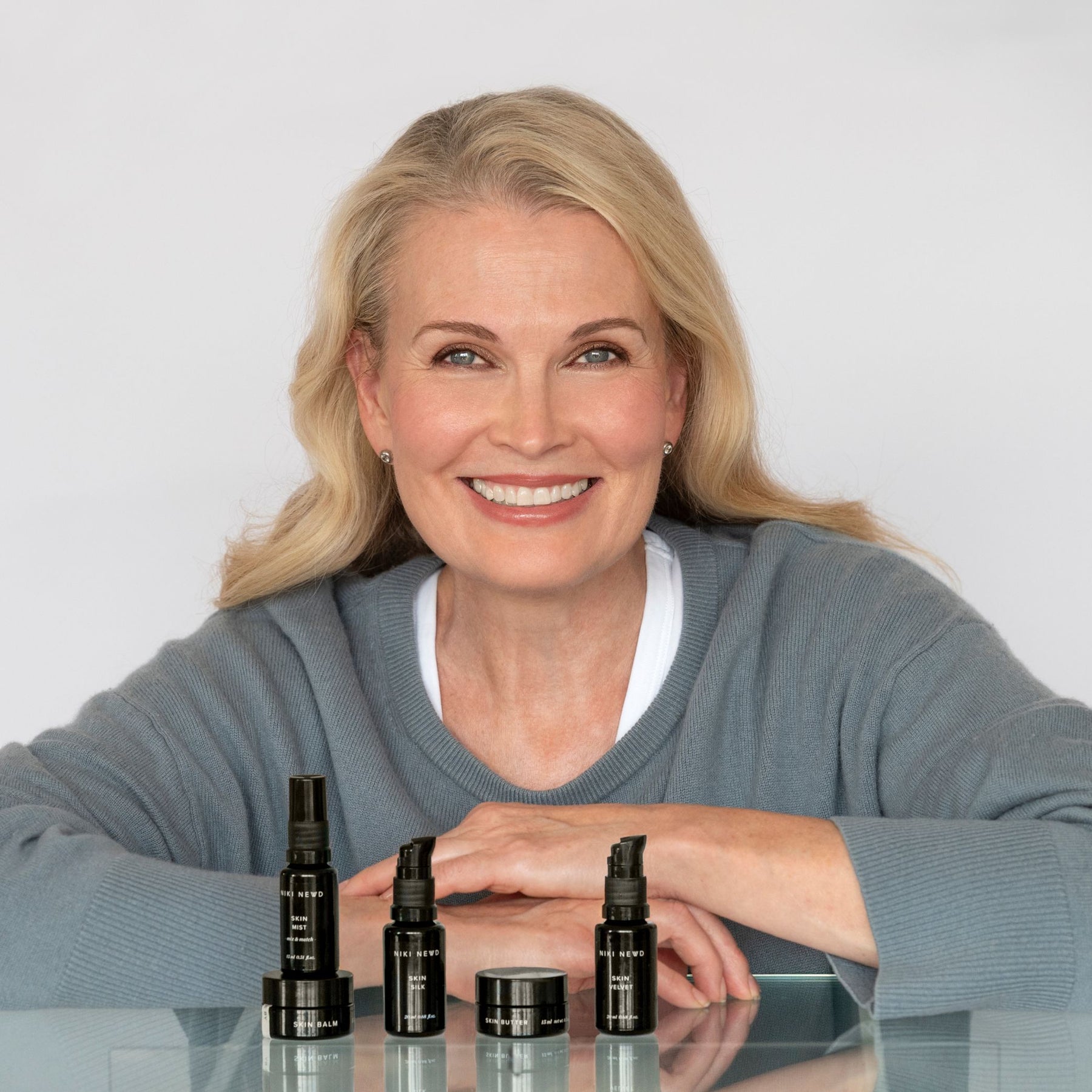 Niki Newd co-founder Kirsi Kaukonen with fresh skincare products — personalised routines for dehydrated, sensitive and ageing skin.