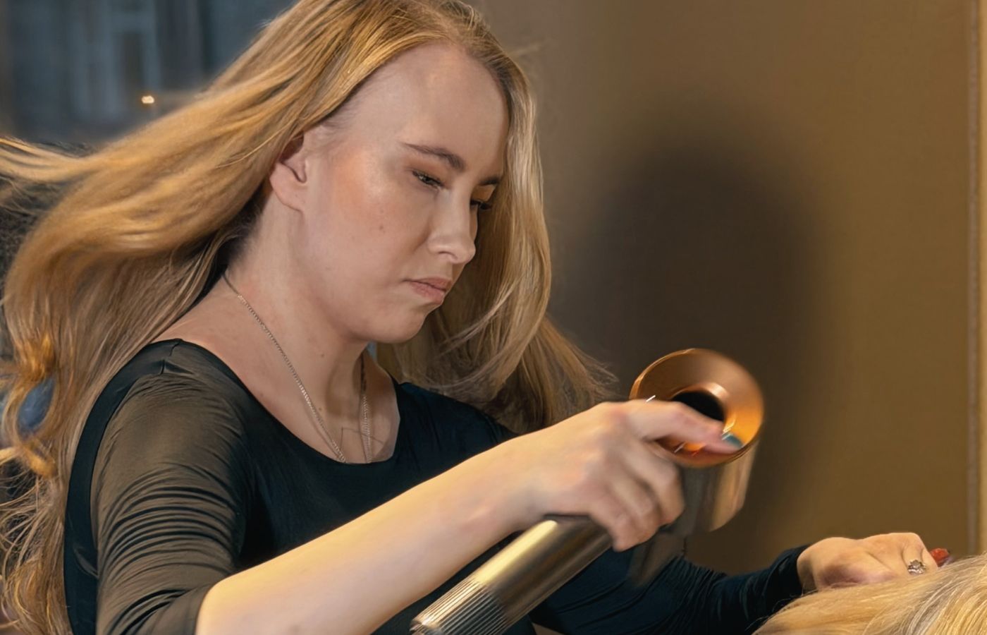 A hair professional at work in the serene Niki Newd Studio hair lounge in Helsinki.