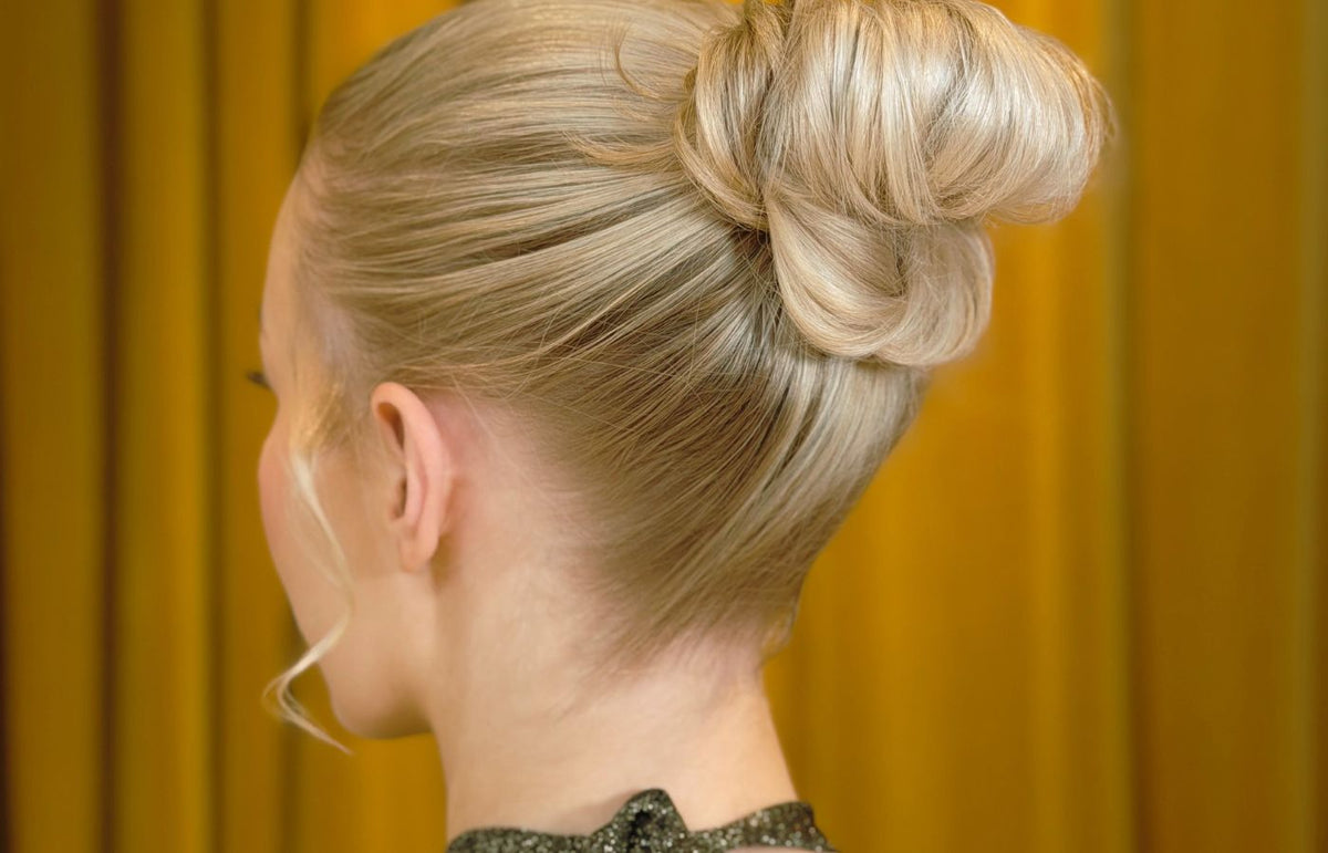 Niki Newd studio specializing in special occasion hairstyling and makeup — hairstylist creating an elegant updo.