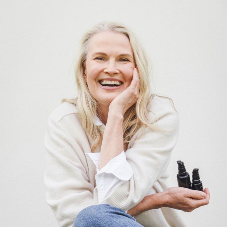 Niki Newd co-founder Kirsi Kaukonen with fresh skincare products — food-grade ingredients, no fillers, no preservatives, pure nourishment for skin longevity.