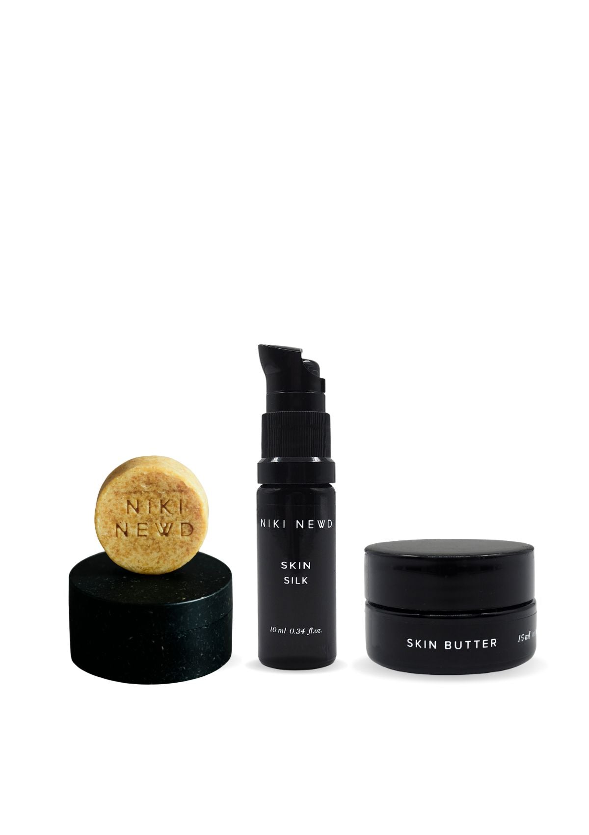 Niki Newd skincare travel set with Oatmeal Soap, Skin Butter, Skin Silk Oil Serum and wooden Soap Case for a complete nourishing travel routine.